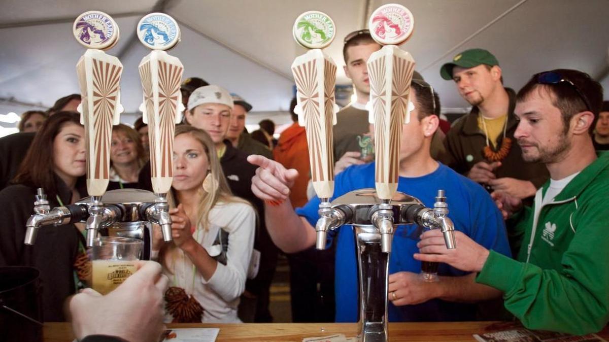 Early arrivals at the World Beer Festival crowd the Mother Earth Brewery taps. The festival, put on by All About Beer magazine, drew thousands to Moore Square. Before the grassroots campaign Pop the Cap, North Carolina was a craft brew wasteland awash in mass market suds.