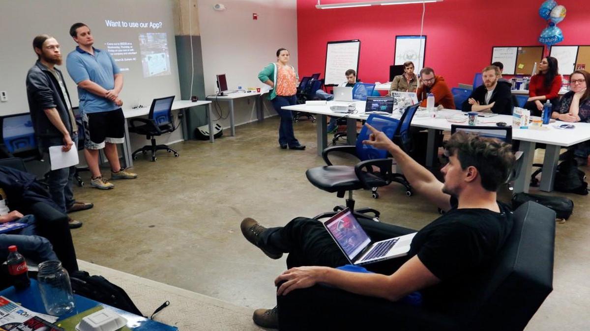 In this file photo, Smashing Boxes coding academy students make a presentation in the Iron Yard coding academy classroom in The Underground at Durham’s American Tobacco Campus. The Iron Yard is shutting down its locations nationwide, including in Raleigh and Durham.