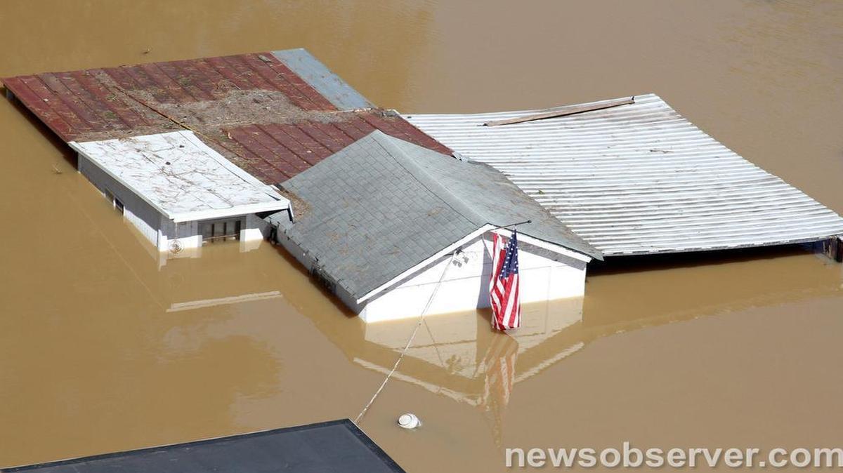 High flood waters surround farm buildings near Smithfield, N.C. Monday, Oct. 10, 2016 after the Neuse River and tributary creeks went over their banks as a result of heavy rains from Hurricane Mathew over the weekend.