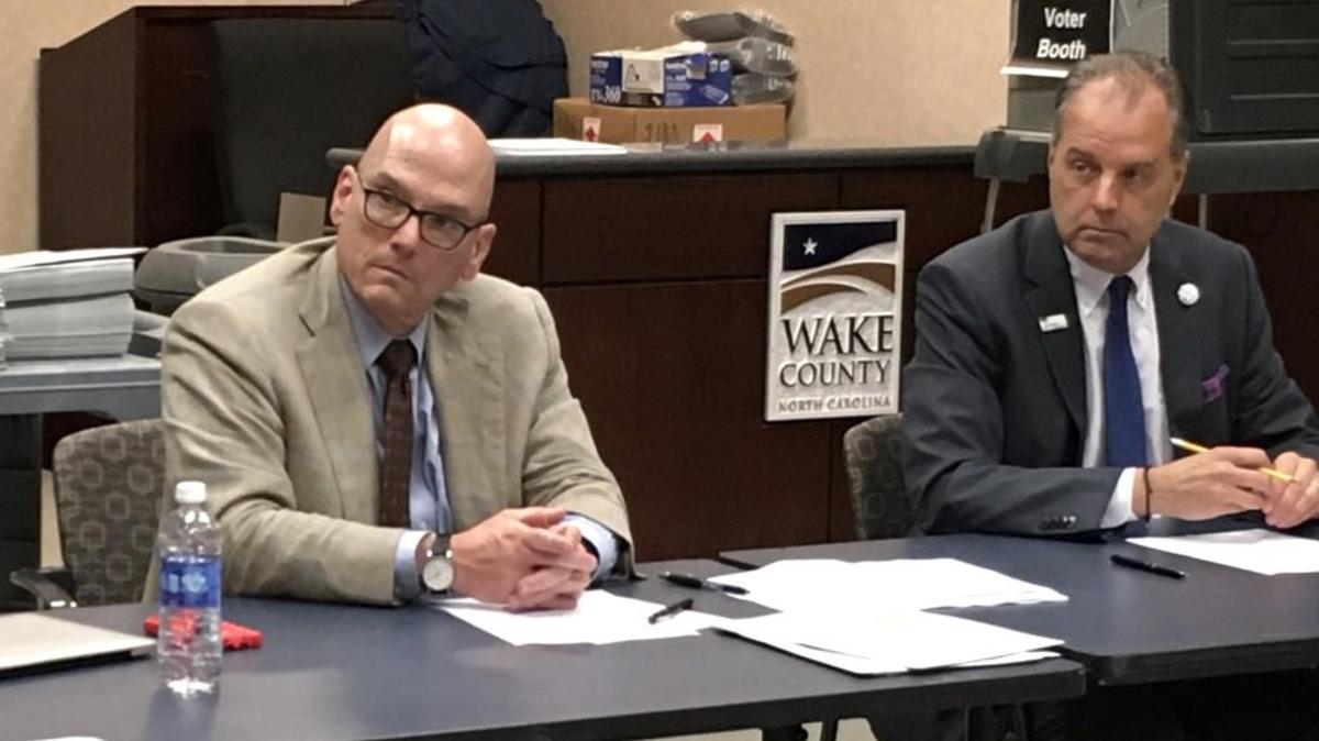 Wake elections board members Mark Ezzell, center, and Eddie Woodhouse, right, listen as Gary Sims, director of the board, gives an update during a board meeting in downtown Raleigh on Oct. 9, 2017.