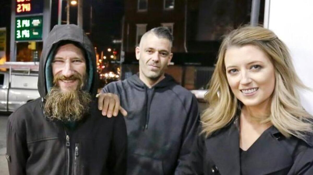 In this Nov. 17, 2017 photo, Johnny Bobbitt Jr., left, Kate McClure, right, and McClure's boyfriend Mark D'Amico pose at a CITGO station in Philadelphia. When McClure ran out of gas, Bobbitt, who was homeless, gave his last $20 to buy gas for her. McClure started a Gofundme.com campaign for Bobbitt that has raised more than $13,000.