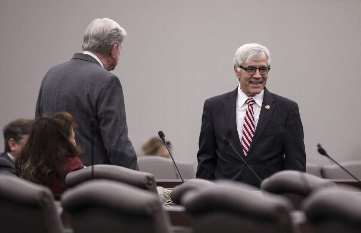 Rep. Harry Warren (R), right, speaks with other legislators in this 2022 photo. Warren introduced a bill in 2025 that would regulate credit card surcharges.
