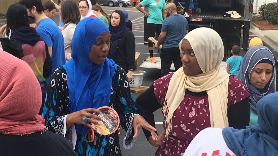 Sisters Zainab Hassell, left, and Mareea Hassell help at Saturday’s food drive at the Islamic Association of Raleigh, which aimed to collect more than 58,000 meals for needy families in memory of three Muslim college students slain in Chapel Hill in 2015.