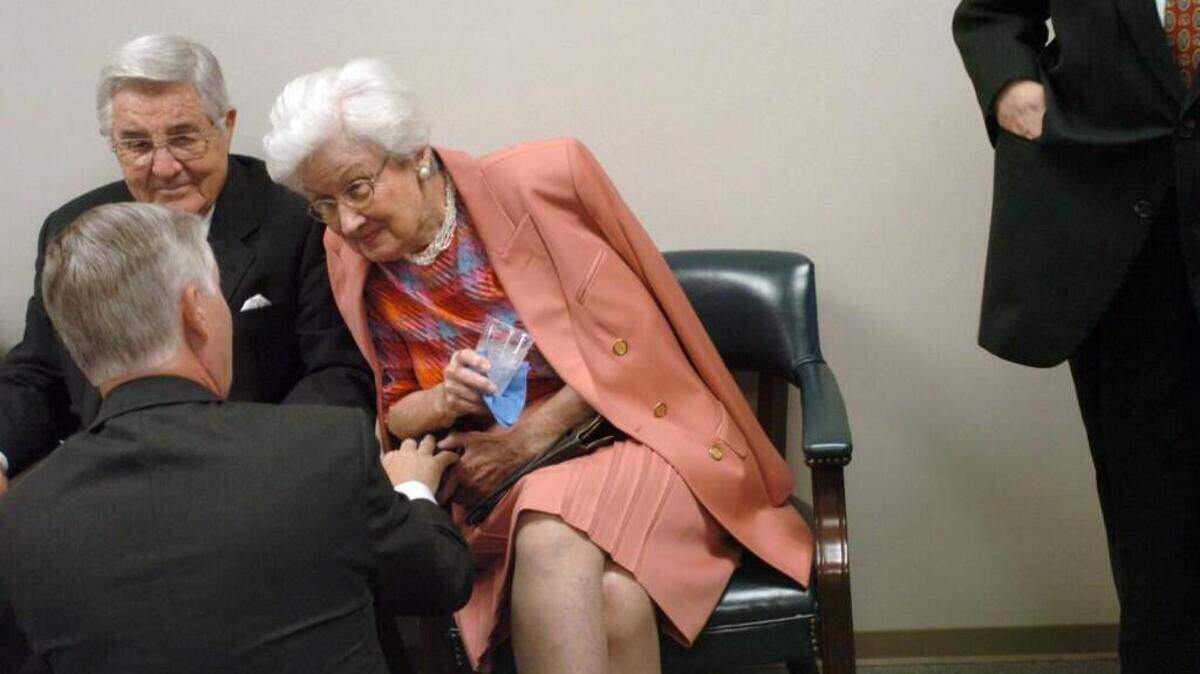 Ida Friday, beside husband Bill, talks with former Gov. Mike Easley, back to camera, in 2004. Ida Friday died Monday at age 97.