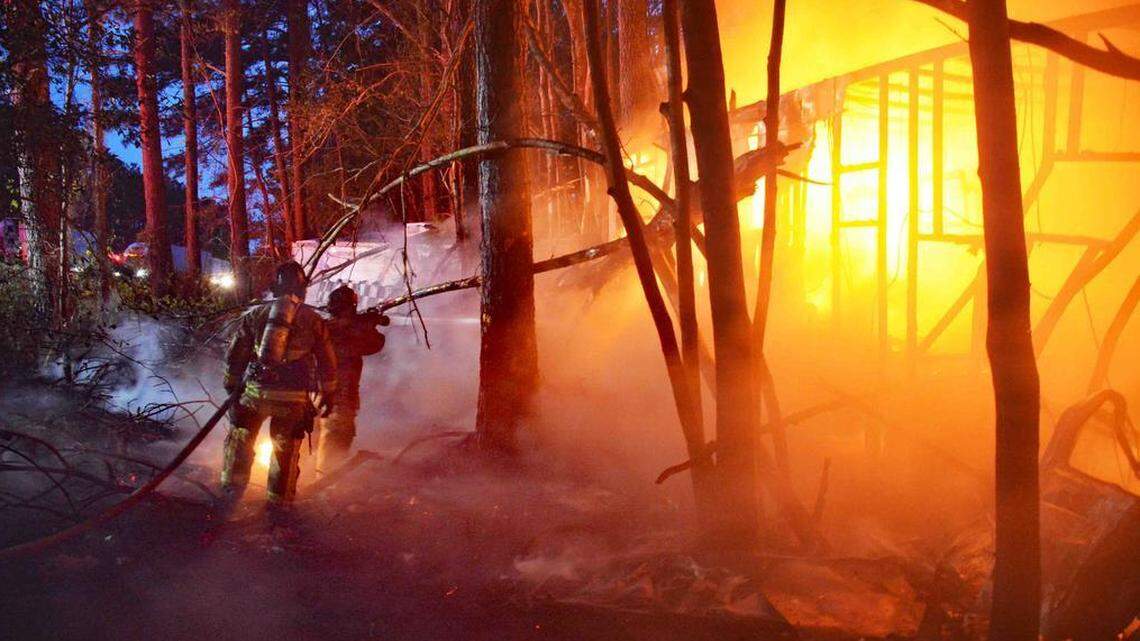Firefighters from Colleton County Fire Rescue put out a fire that consumed a motorhome in a wooded median on Interstate 95 in Walterboro, South Carolina, on Thursday, March 29, 2018. Timothy Hunley, who was driving on the interstate in a separate car, pulled a woman from the burning motorhome and saved her life.