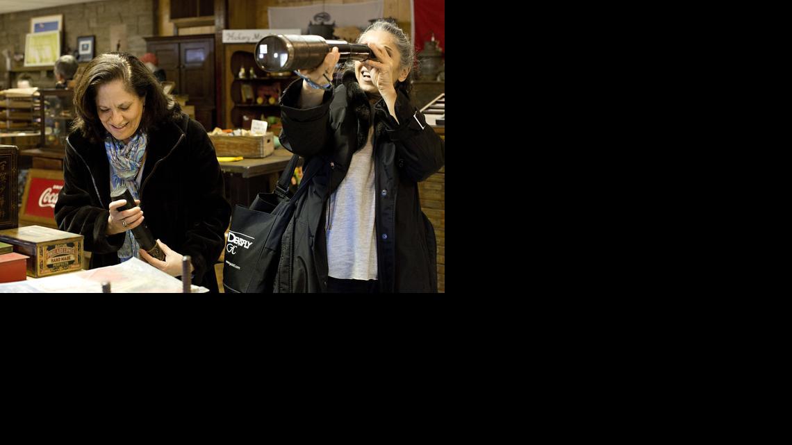 
Nancy Kenna, left, and her sister Mary Paula Zaytoun try out antique military telescopes at High Pockets Antiques' booth during an antique fair benefitting American Legion Post 6 Sunday, March 29, 2015 in Chapel Hill, N.C. The large telescope, pictured right, is an old naval telescope. The smaller telescope, pictured left, is an old calvary telescope from the Civil War.
