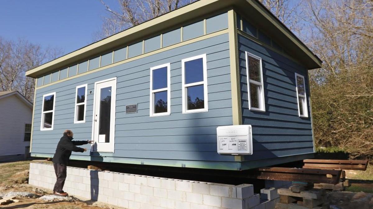 Thava Mahadevan, Director of Operations for UNC’s Center for Excellence in Community Mental Health is excited to show visitors the first project tiny house, a 12 foot x 28 foot one-story house at The Farm on Penny Lane in Chatham County. The 336 square foot house is the pilot house, the first of several where clients with mental illness will be able to live inexpensively in a planned tiny house community for people with mental illnesses just south of Chapel Hill.