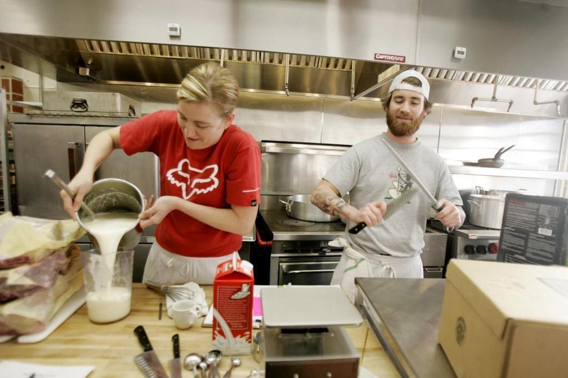 Poole’s owner Ashley Christensen, left, and cook, Sunny Gerhart, right, prepare for a busy night at the downtown Raleigh restaurant on their second night open Friday, December 14, 2007.
