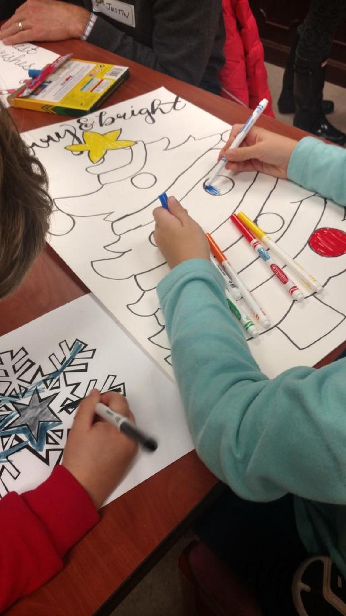 Children make holiday decorations at InterAct. The agency hosts a holiday shop for the mothers and their children.
