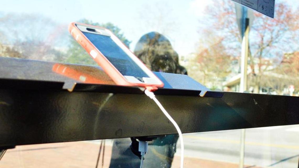 Students can charge their mobile devices at the Dan Allen Drive bus stop on N.C. State’s central campus.