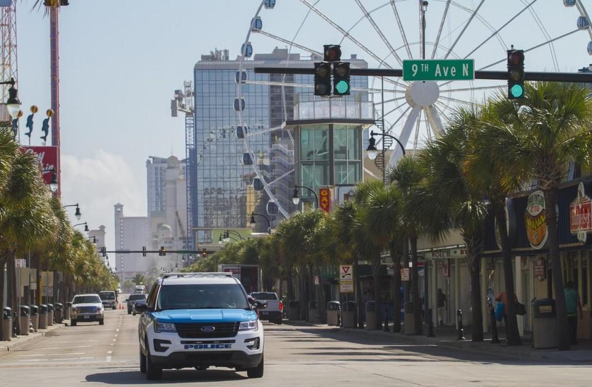 Police patrol a quiet Ocean Boulevard on Monday morning, a day after the shooting that injured seven people. Myrtle Beach, June 17, 2017.