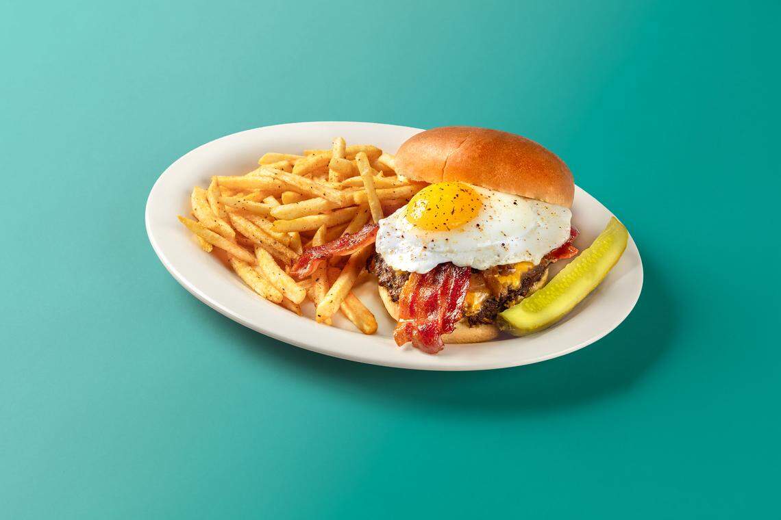 The Brunch Burger from Eggs Up is topped with American cheese, maple caramelized onions, bacon and an egg.