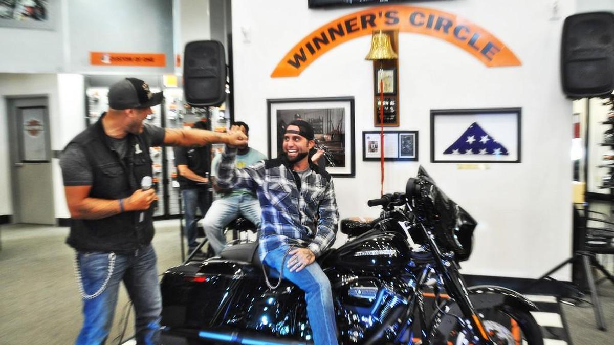 Adam Sandoval, left, surprises Jeremy Thomas with a new Harley-Davidson motorcycle Oct. 19, 2017. Sandoval has joined with Harley-Davidson and the Wounded Warrior Project to give away eight Harleys as part of “Mission: Thank You.” The first bike went to Thomas of Raleigh, a U.S. Army veteran injured during the Iraq War.