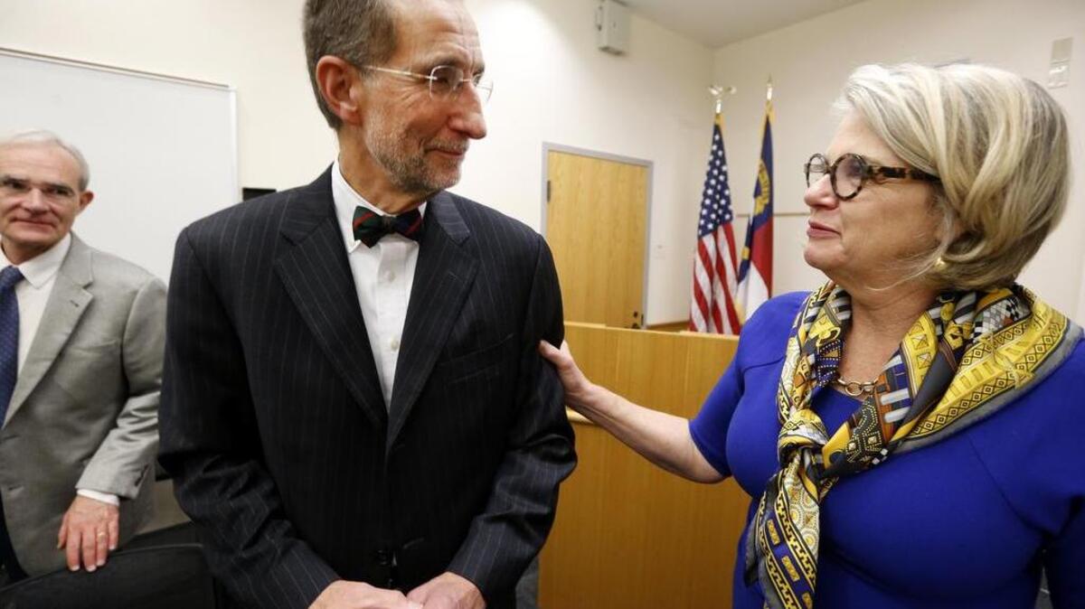 UNC President Margaret Spellings congratulates Dr. William Roper after he was named UNC system interim president at the UNC Board of Governors meeting at the UNC Center for School Leadership Development in Chapel Hill, N.C., Thursday, Nov. 1, 2018.
