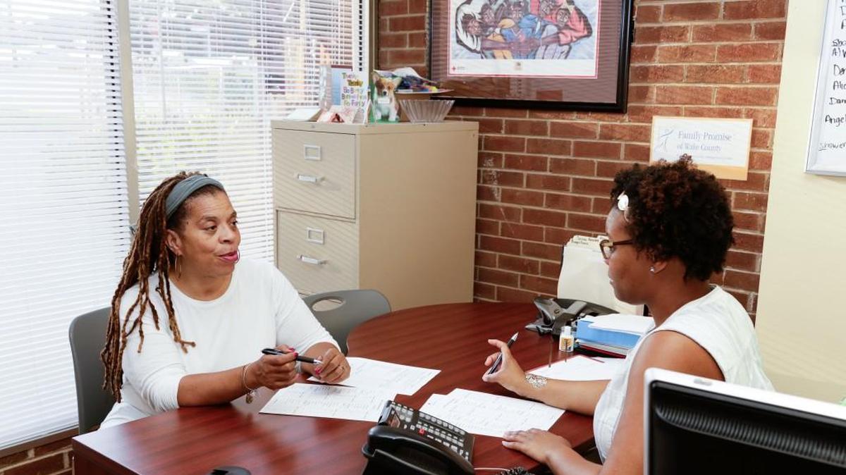 A former Family Promise of Wake County client receives case management services from case manager Shakeda Muldrow at the Method Road Day Center.