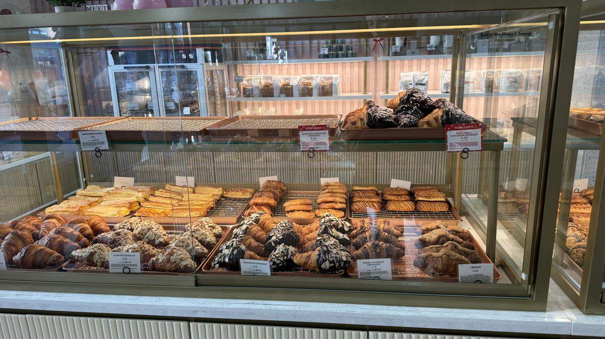 A display case at the new Raleigh bakery Tous Les Jours displays almond, chocolate and cocoa hazelnut croissants.