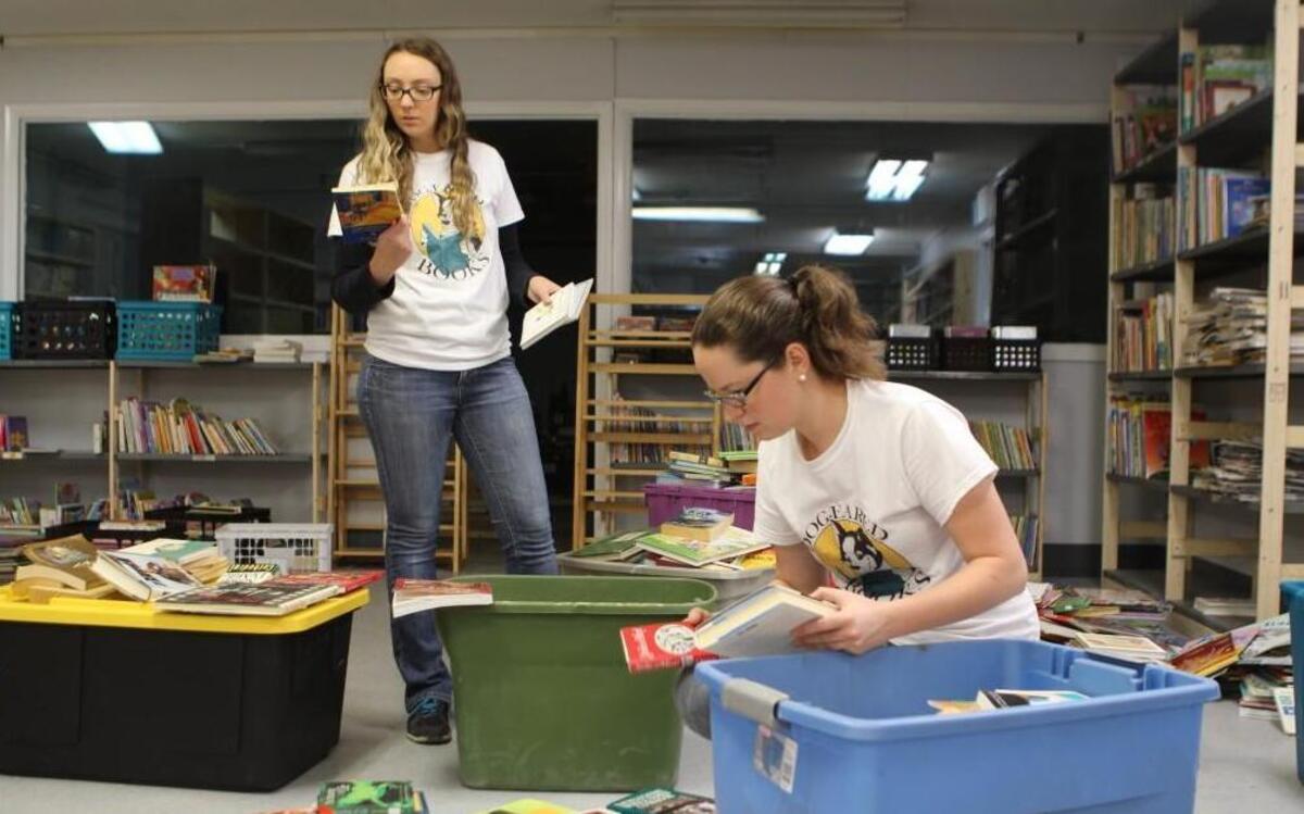 Stephanie Stegemoller, left, and Caitlynne Garland sort books Thursday, April 20, 2017. They will open Dog-Eared Books on Atlantic Avenue in Raleigh on April 29.