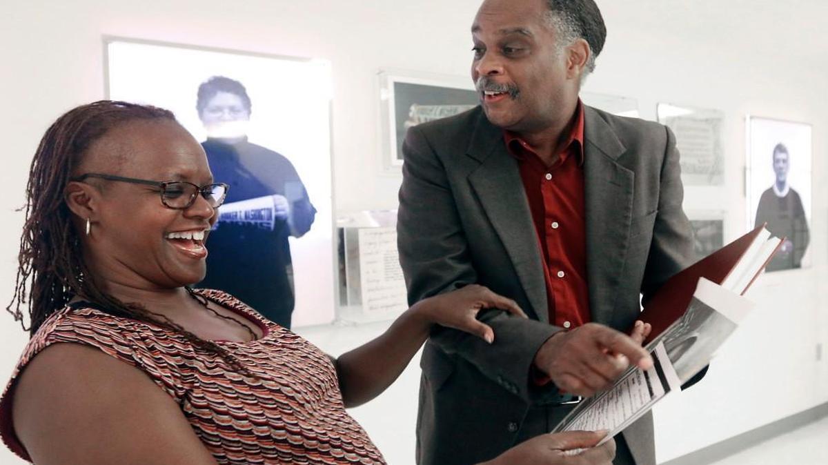 Ancestry search client Gail Burden, left, of Raleigh, reacts when she sees the 1932 Goldsboro, NC marriage certificate of her grandparents and the signatures of her great-grandparents on the certificate shown to her by Alonzo Felder, My Roots Foundation founder, during a meeting at Duke University Medical Center October 14. Felder, 60, a Duke University staffer for 31 years has been a family history researcher for 15 years emphasizing African-American genealogies.