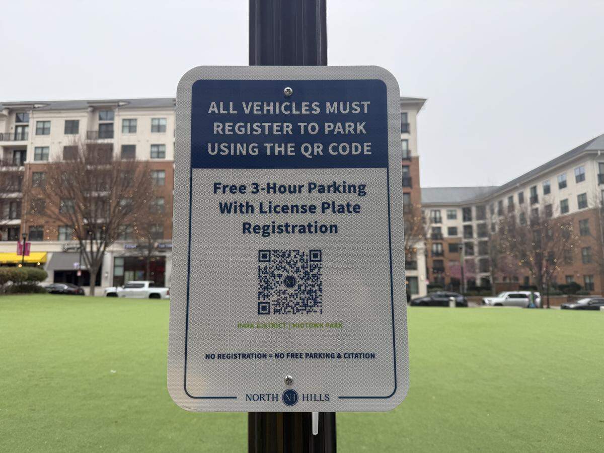 Signs with QR codes posted in the North Hills Park District prompt visitors to register their vehicles to park.