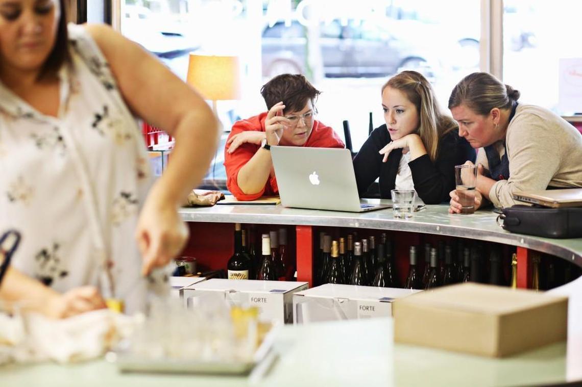 Poole’s general manager Lesley Anderson, left, AC Restaurants brand director Kaitlyn Goalen, and chef Ashley Christensen look over the seating charts Oct. 29, 2017, at Poole’s Diner in downtown Raleigh as they prepare for their Stir the Pot event, which benefits the Southern Foodways Alliance.