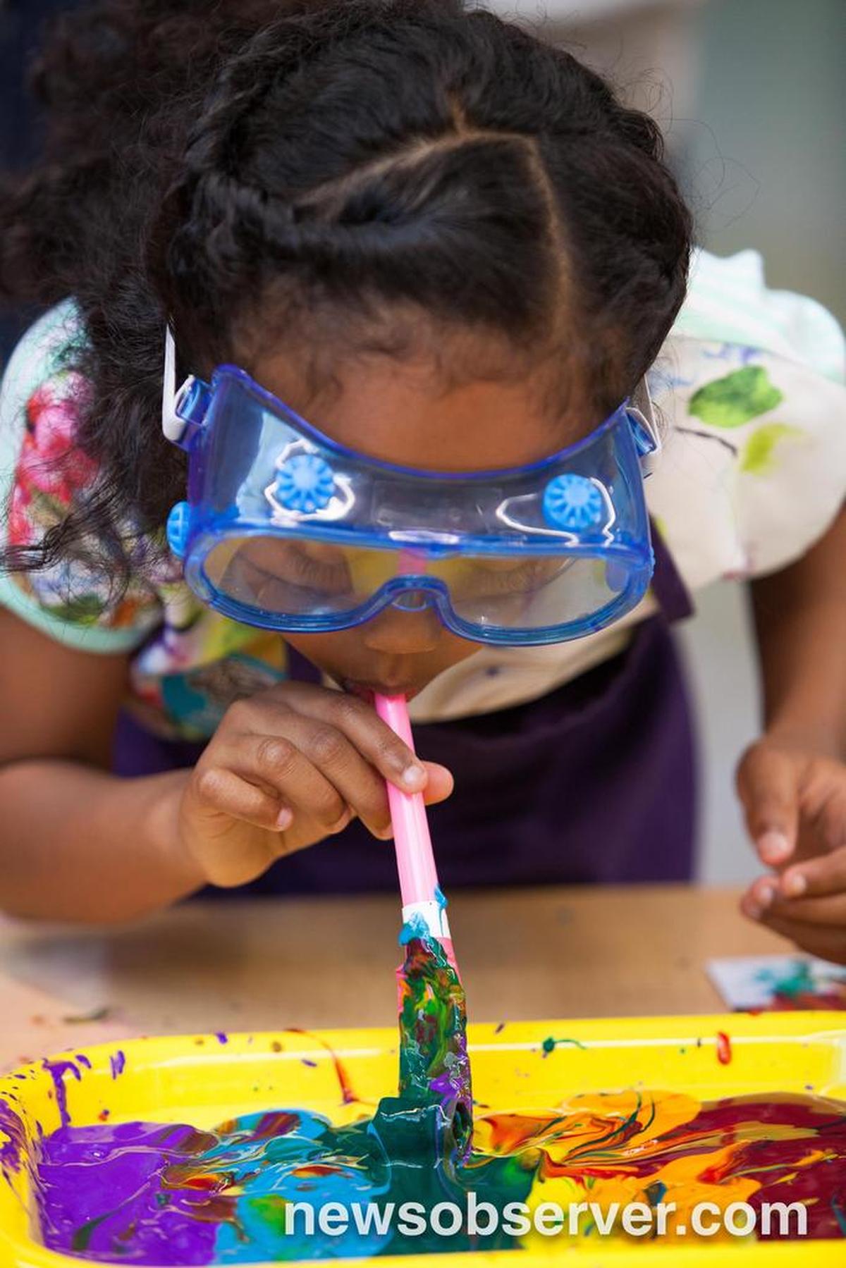 Carmen Pasive, age 8, uses a “tongue” like a frog to make artwork during an educational event at Marbles Kids Museum in Raleigh, N.C. on Sunday, Apr. 24, 2016.