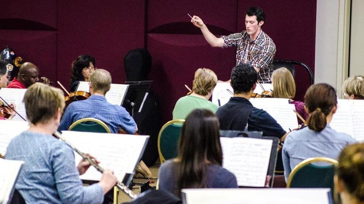 Jackson Cooper, executive director of Chamber Music Raleigh, conducts the Durham Symphony during a rehearsal.