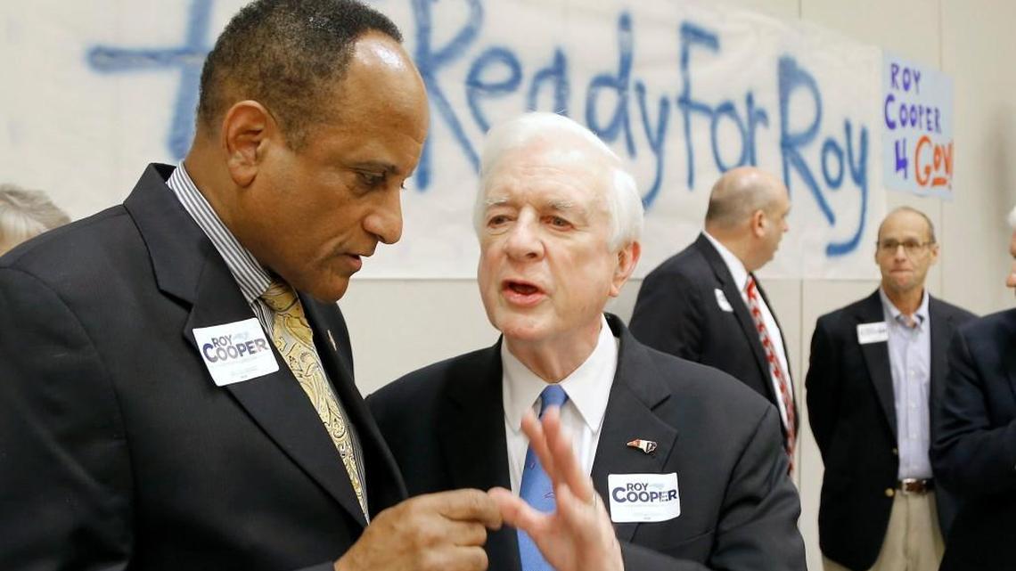 Former state Rep. Larry Hall, left, talks with former N.C. Governor Jim Hunt before a Roy Cooper event in October 2015. The African-American Caucus of the N.C. Democratic Party wants to remove Hunt’s name from the party’s annual fundraiser.