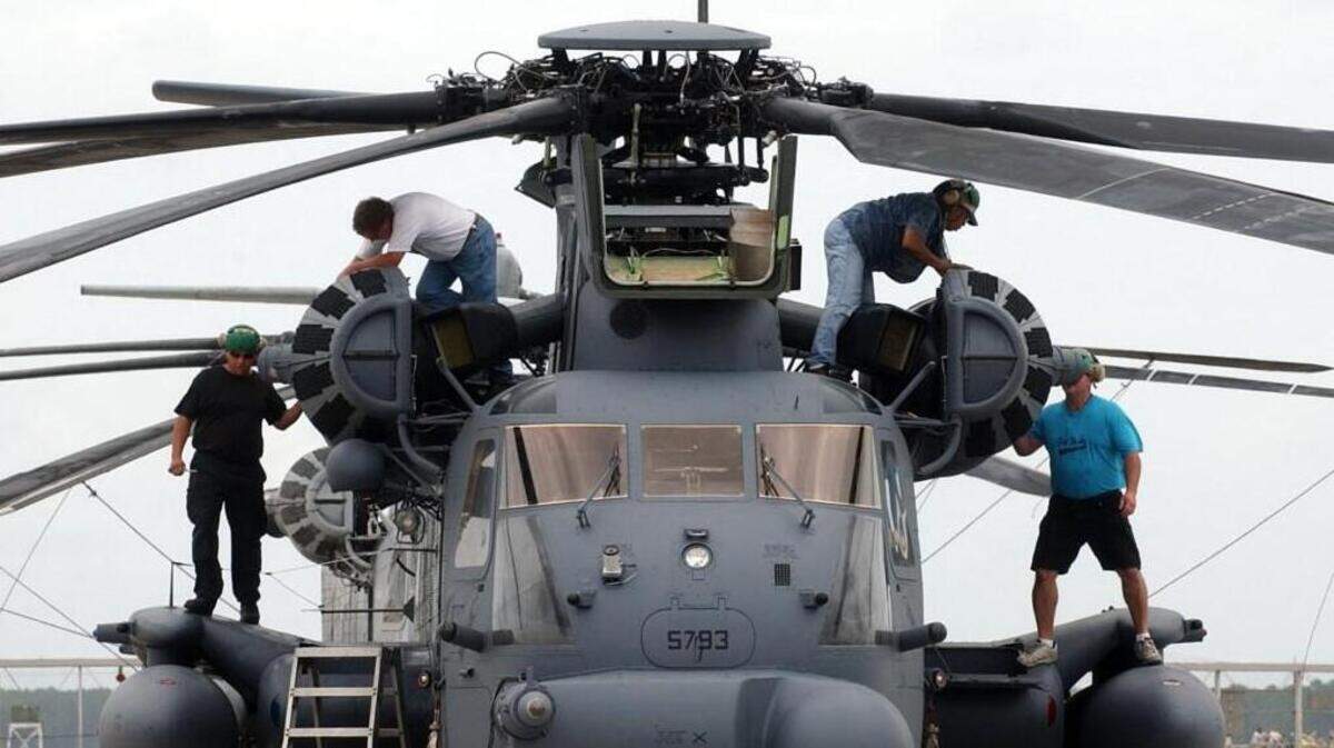 In this 2004 file photo, workmen scurry over a H-53 Super Stallion at the Naval Air Depot facility at Cherry Point Marine Corps Air Station.