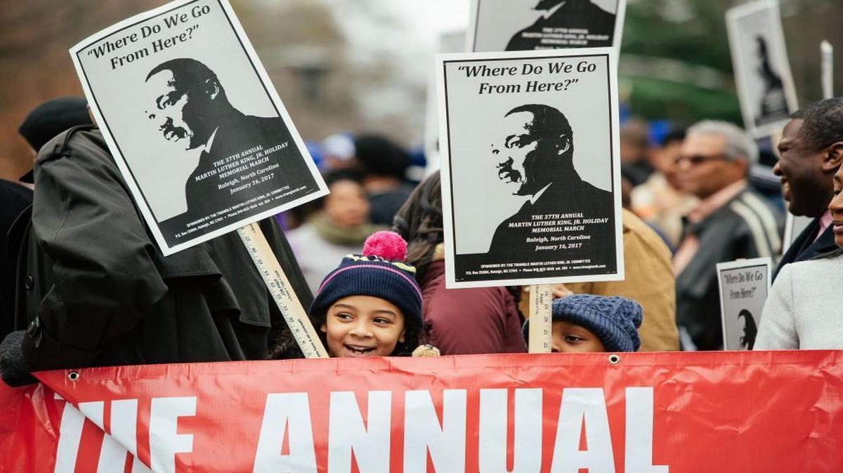 Young participants carry signs prior to the 37th annual Martin Luther King, Jr. Holiday Memorial March in 2017. The 2018 march is Jan. 15, departing at 11 a.m. from the State Capitol.