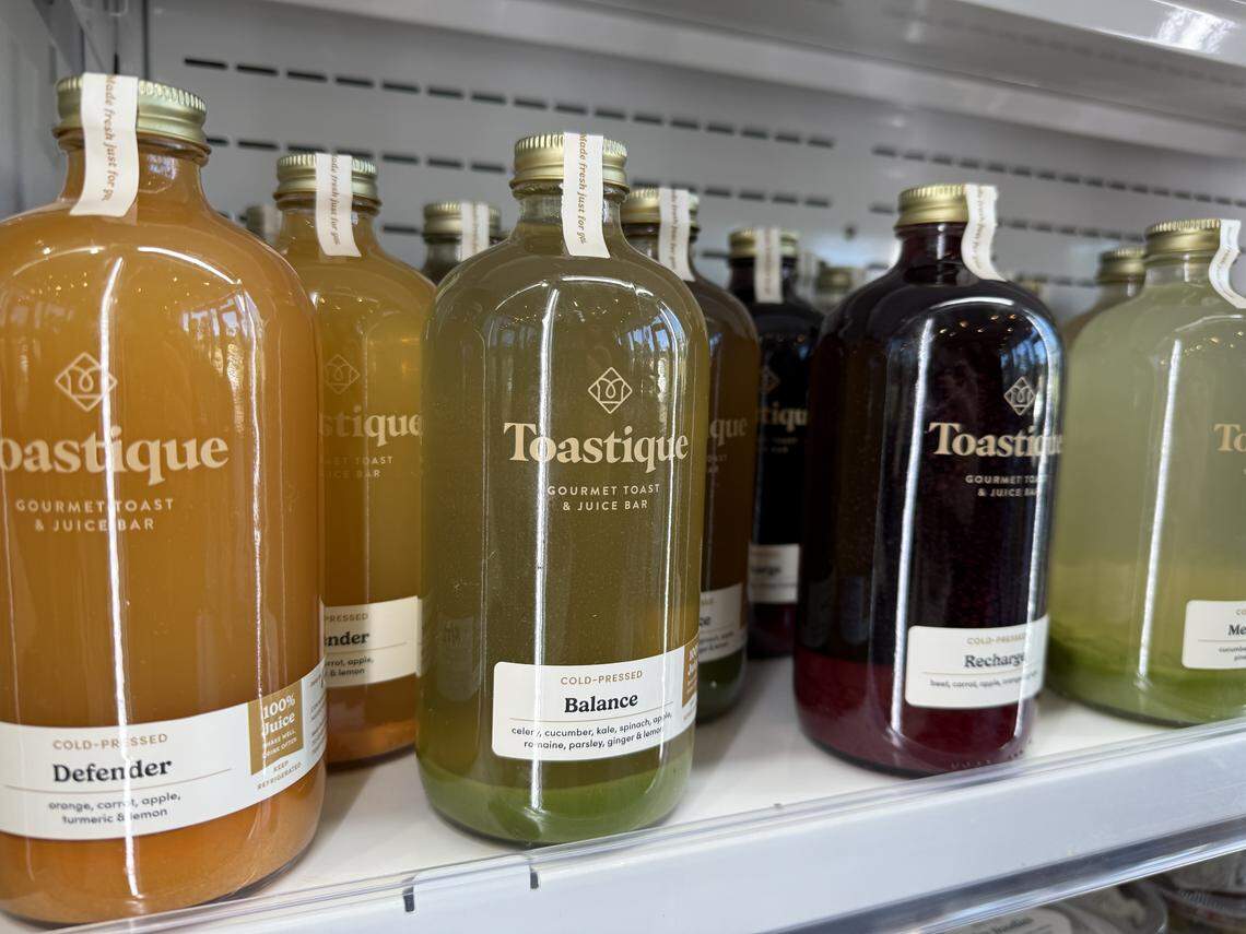 Bottles of cold-pressed juices from Toastique are displayed in a grab-and-go refrigerator.