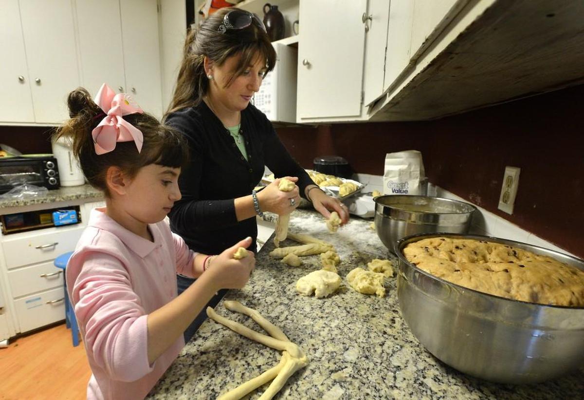 Yehudis Bluming gets help making challah from her daughter Chaya for of Rosh Hashana and Yom Kippuri in Chapel Hill in 2013.