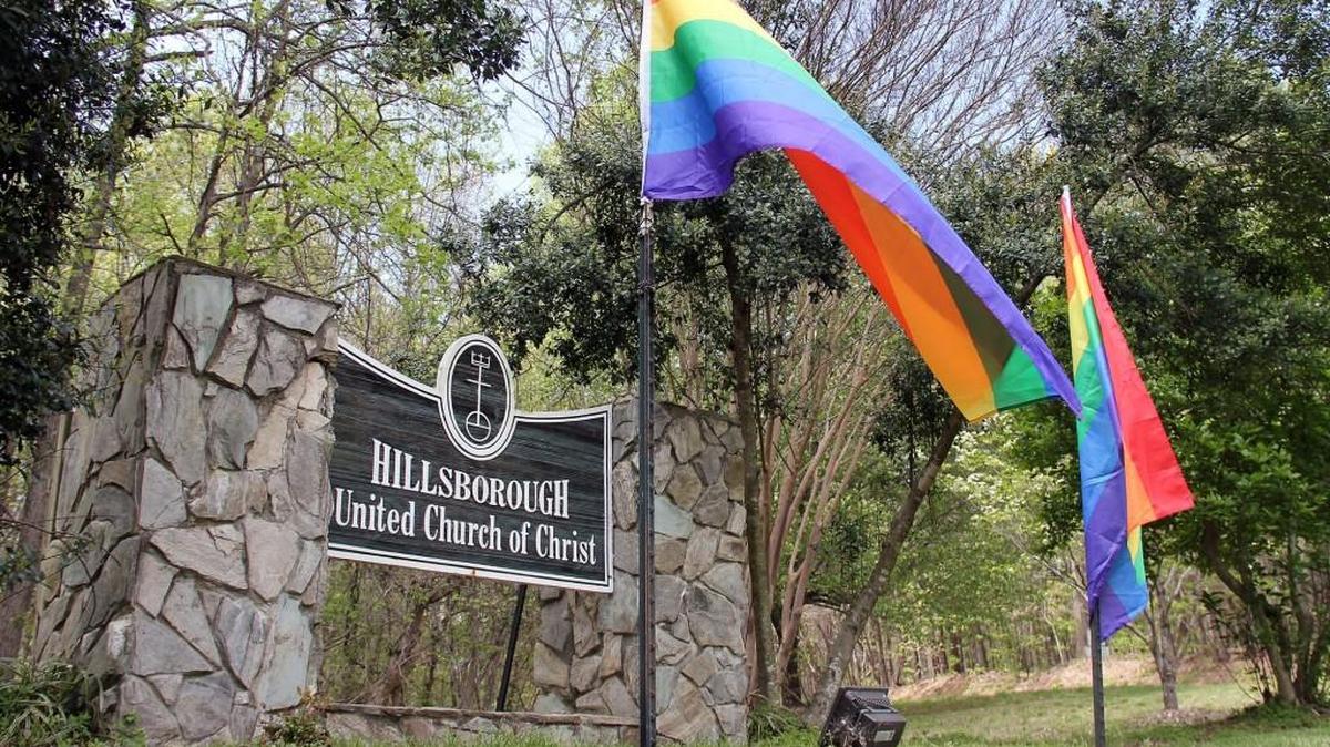 Two LGBTQ flags hang Monday, April 11, 2016, outside the United Church of Christ in Hillsborough. The church put up two new rainbow flags after someone burned two other rainbow flags there sometime Friday night. The church wanted “to let the (LGBTQ) community know there was a church that supported them and welcomed them,” the Rev. Jay Kennett said.