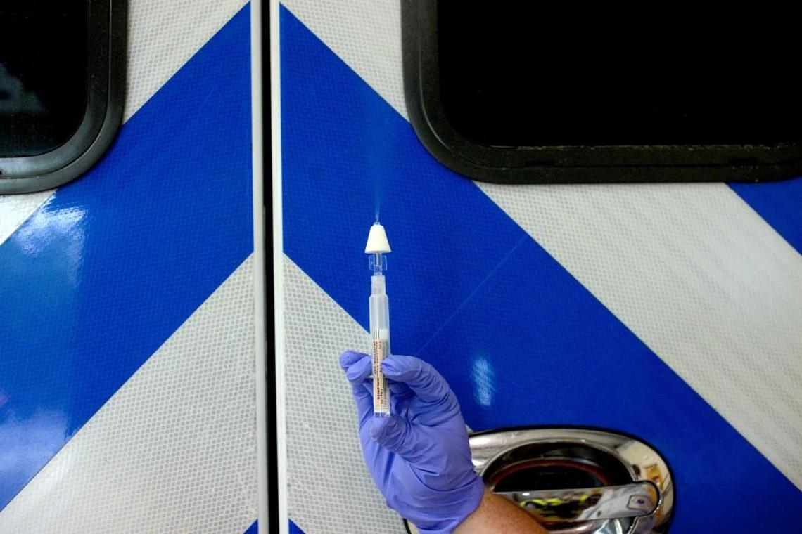 A paramedic demonstrates how naloxone is administered to someone overdosing on opioids.