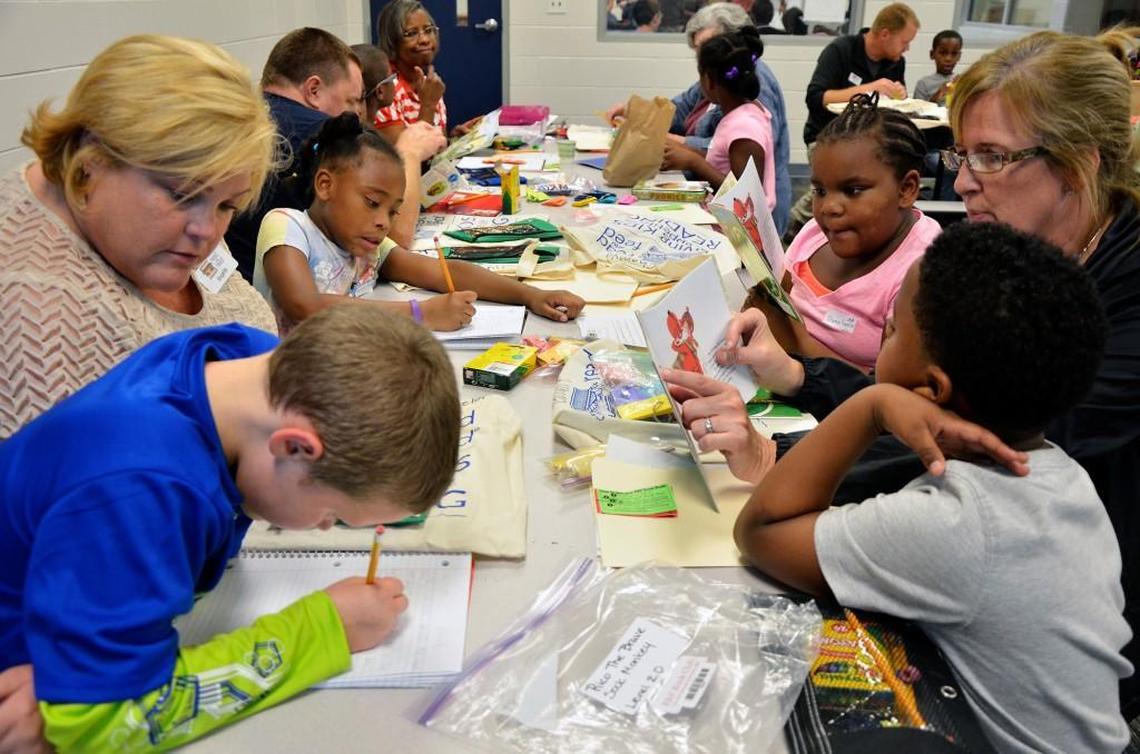 Zebulon Boys & Girls Club members work with volunteers on their reading and writing skills as part of the Read and Feed program in this 2015 file photo.