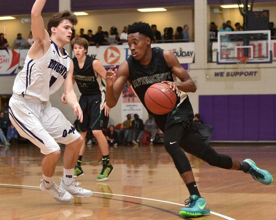 Ravenscroft's Michael Okauru (10 ) drives to the lane while guarded by Broughton's Aaron Gottfried (4) during the first half. The Broughton Capitals took on the Ravenscroft Ravens in the first round of the HighSchoolOT.com Holiday Tournament at Broughton High School in Raleigh, N.C. on December 26, 2015. Ravenscroft leads 34-26 at the half.