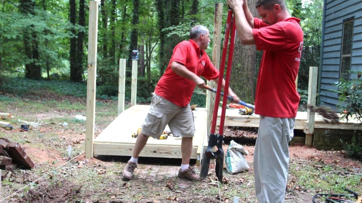 A crew from Mr. Handyman of Western Wake County builds a wheelchair ramp for Lynn Potter, who has been away from her North Raleigh home for two years while she received medical treatment.