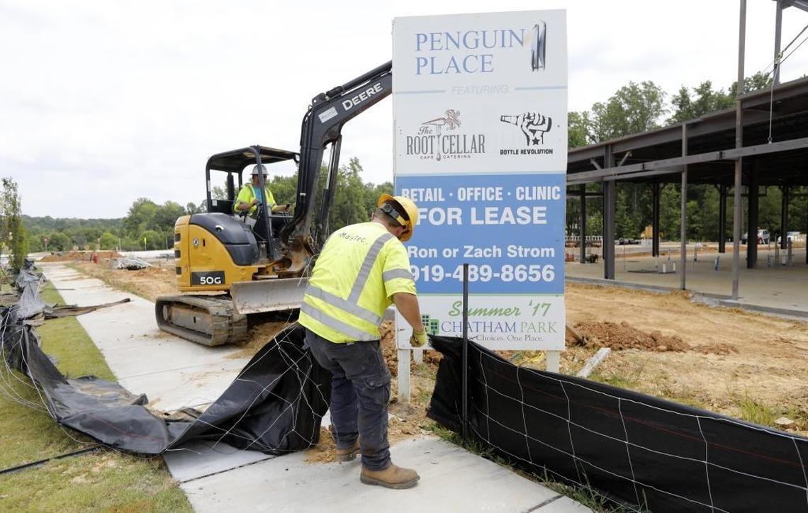 Derrick Kidd with MasTec works at Penguin Place, a retail development in the new Chatham Park development in Pittsboro, N.C., Thursday, July 27, 2017.