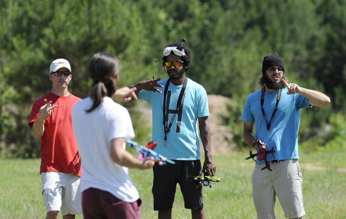 Andy Smith, left, Max Dorsey and James Coleman line up before the start of a quadcopter race in Sanford, N.C., on Saturday, May 27, 2017. Participants attempted to complete three laps around the course in under 2 minutes.