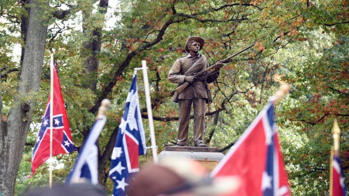 Confederate flags frame ‘Silent Sam’ during a rally on the UNC campus in 2015. The rally, held in support of keeping the monument on campus, was held by Alamance County Taking Back Alamance County.