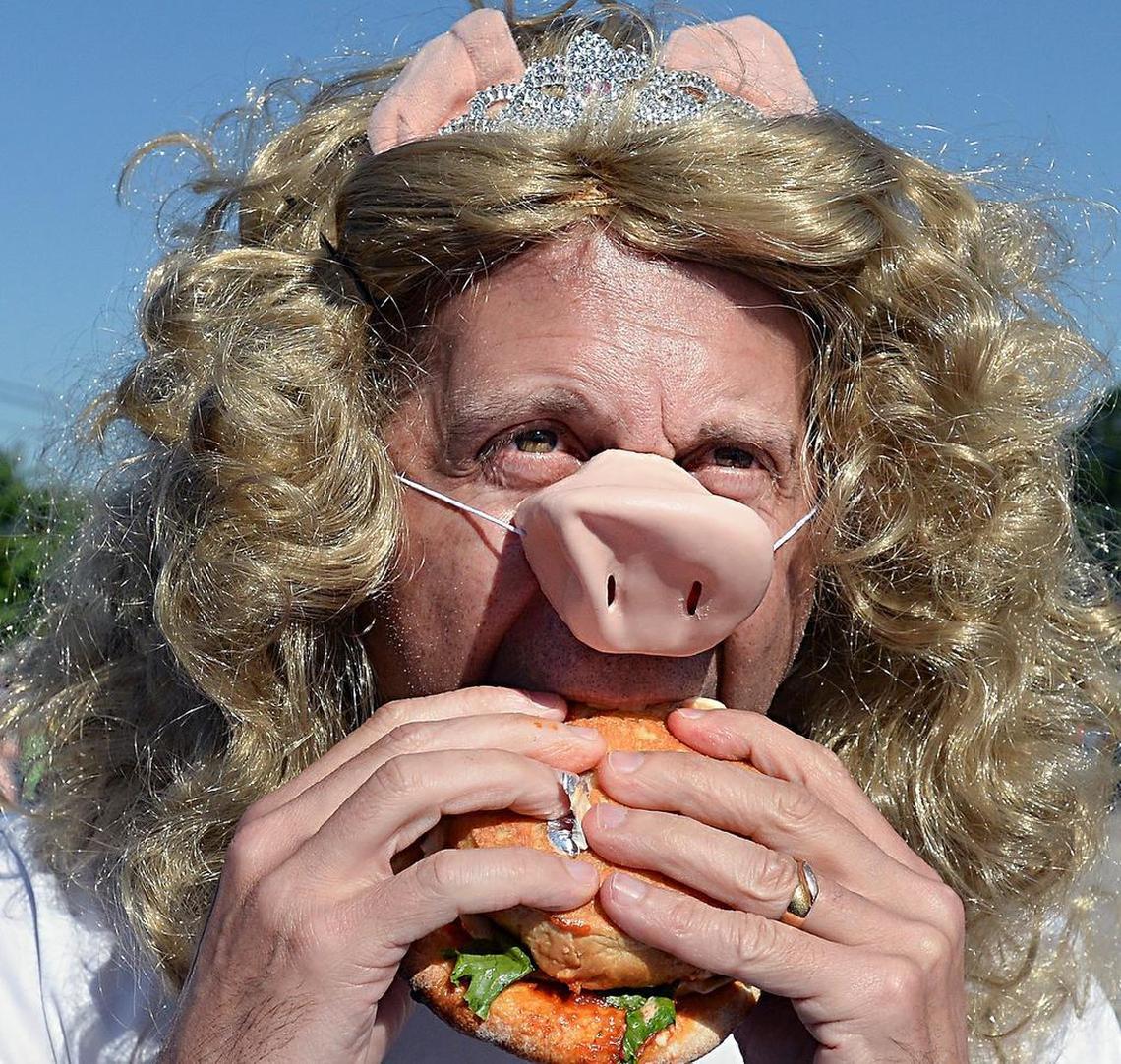 Gary Gartner, part of the Piggy Galore team chows down on a Bull City Burger & Brewery's Burizza.