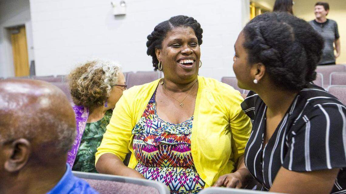 Latarndra Strong, founder of the Hate-Free Schools Coalition, celebrates with her daughter Marilyn Allen as the Orange County school board votes to approve an amendment to the dress code addressing 'racially intimidating' articles of clothing on Monday, July 12, 2017, in Chapel Hill, NC.