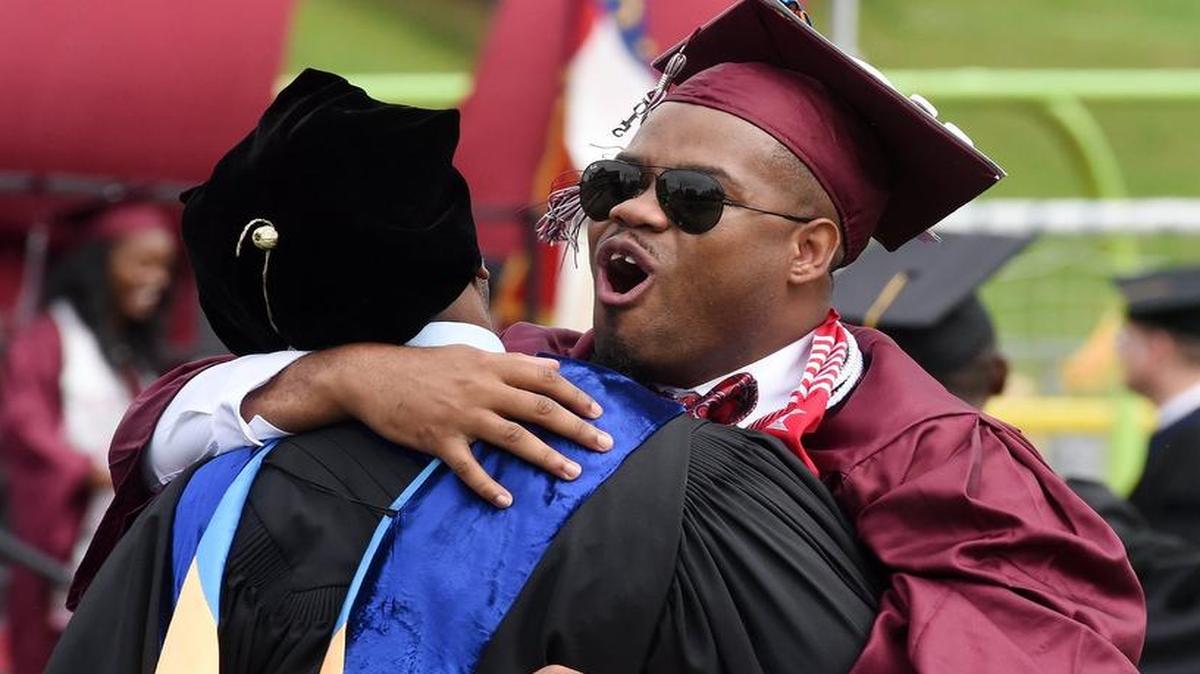 
Warren Clayton shouts with joy as he hugs Dr. Russell Robinson, a professor and fellow fraternity brother, after receiving his diploma during the 125th Commencement exercise for NCCU at O'Kelly-Riddick Stadium on the campus of North Carolina Central University in Durham Saturday, May 9, 2015.
