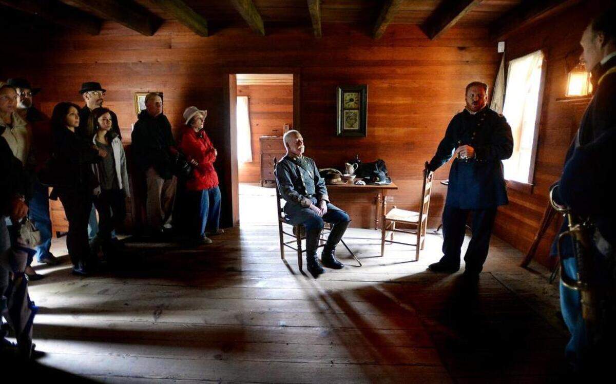 
Visitors watch as Confederate Gen. Joseph E. Johnston listens to Union Gen. William T. Sherman at Bennett Place in Durham, NC Saturday, April 25, 2015. In April 1865, the two commanders met at the Bennett Place, where they signed surrender papers for Southern armies in the Carolinas, Georgia, and Florida. It was the largest troop surrender of the American Civil War. Craig Braswell (sitting) is Johnston and John Guss portrays Sherman.
