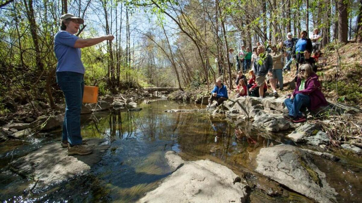Kathi Beratan, left, leads a geology tour at Ellerbe Creek during The Rocks Nature Preserve Celebration in Durham, N.C. on Sunday, Apr. 2, 2017.