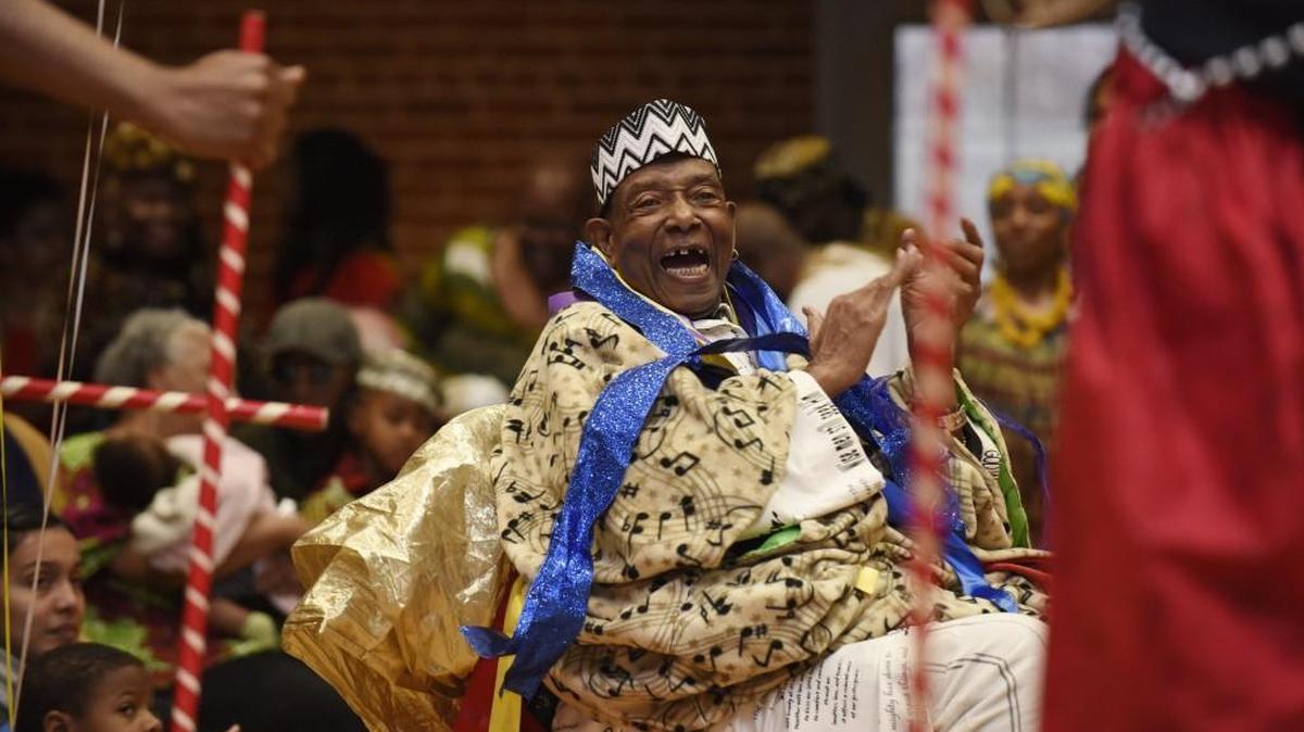Chuck Davis claps as the African American Dance Ensemble takes the floor at the 31st annual KwanzaaFest Celebration in Durham, N.C. on Sunday, January 1, 2017. Davis is the founder and artistic director of the ensemble. He also celebrated his 80th birthday at the end of Kwanzaa celebration.