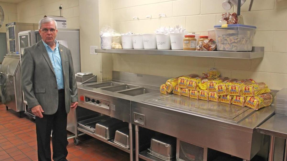 Johnston County Sheriff Steve Bizzell stands in the kitchen where jail staff assemble nearly 700 meals every day for inmates. The kitchen was built to prepare 300 meals a day.