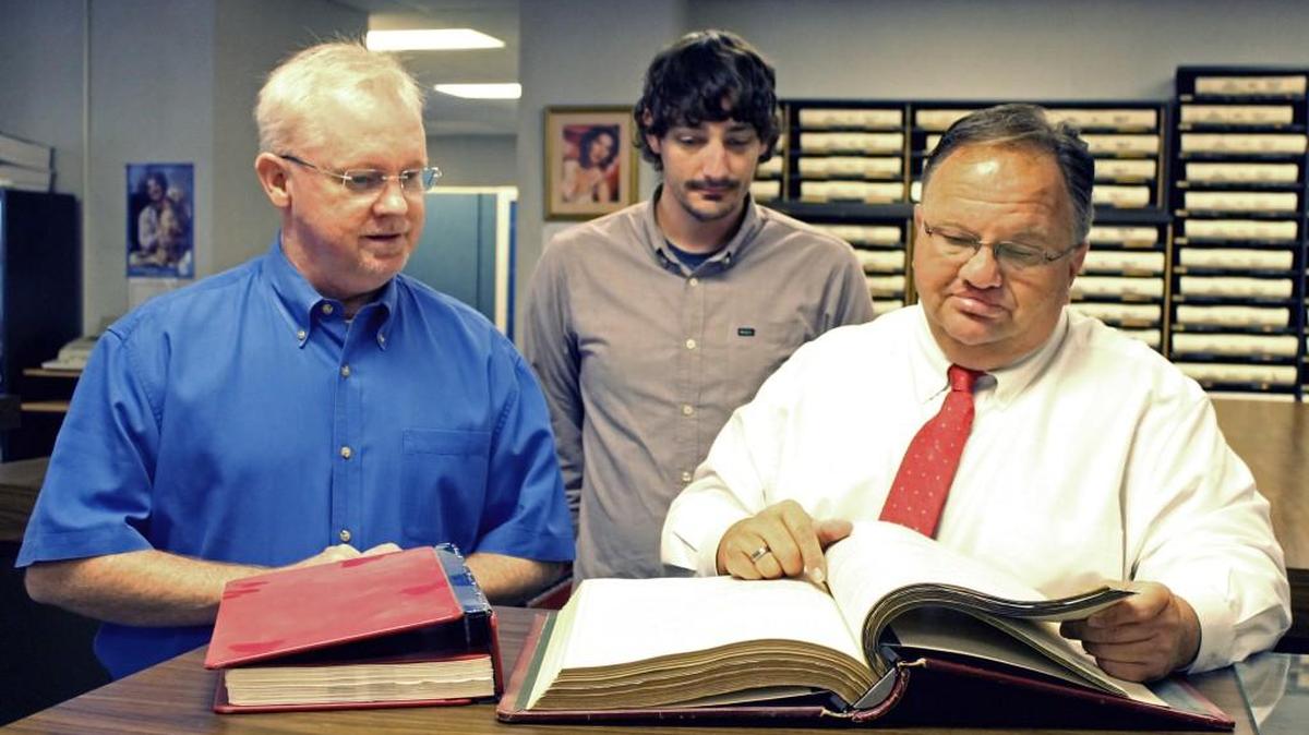 From right, Johnston County Registrar of Deeds Craig Olive, computer analyst Jeff Wilson and Robert Boyette Jr., director of the Johnston County Veterans Service Office, look over archived military-discharge papers in the Register of Deeds Office.