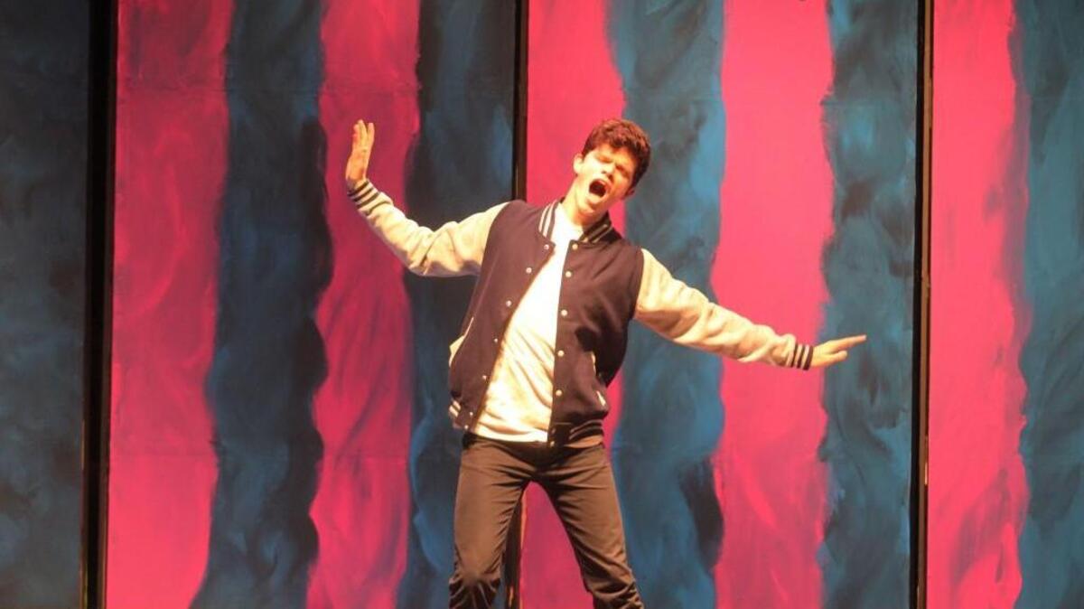 Nicholas Kraft rehearses a song in the lead role of Franke Abagnale Jr. in “Catch Me If You Can,” playing this weekend at Clayton High School.