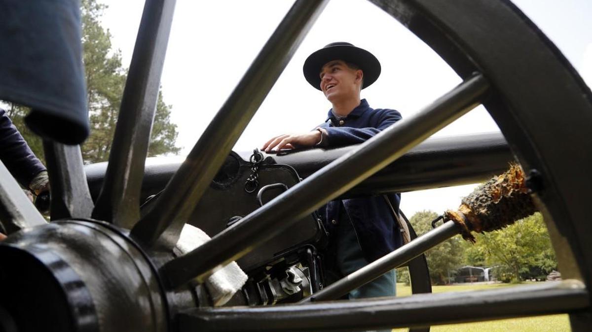 Civil War re-enactor David Bourhenne, in a Union uniform, smiles after helping fire a cannon during an artillery demonstration at Bentonville Battlefield State Historic Site near Four Oaks on Aug. 26, 2017.