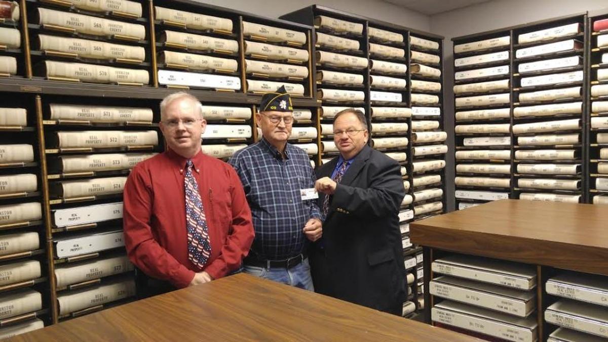 The first veteran to benefit from Johnston County’s “Thank a Vet” ID card program, Gerald Young, center, of Benson, is shown with with Johnston County Veterans Service office Robert Boyette, left, and county Registrar of Deeds Craig Olive.